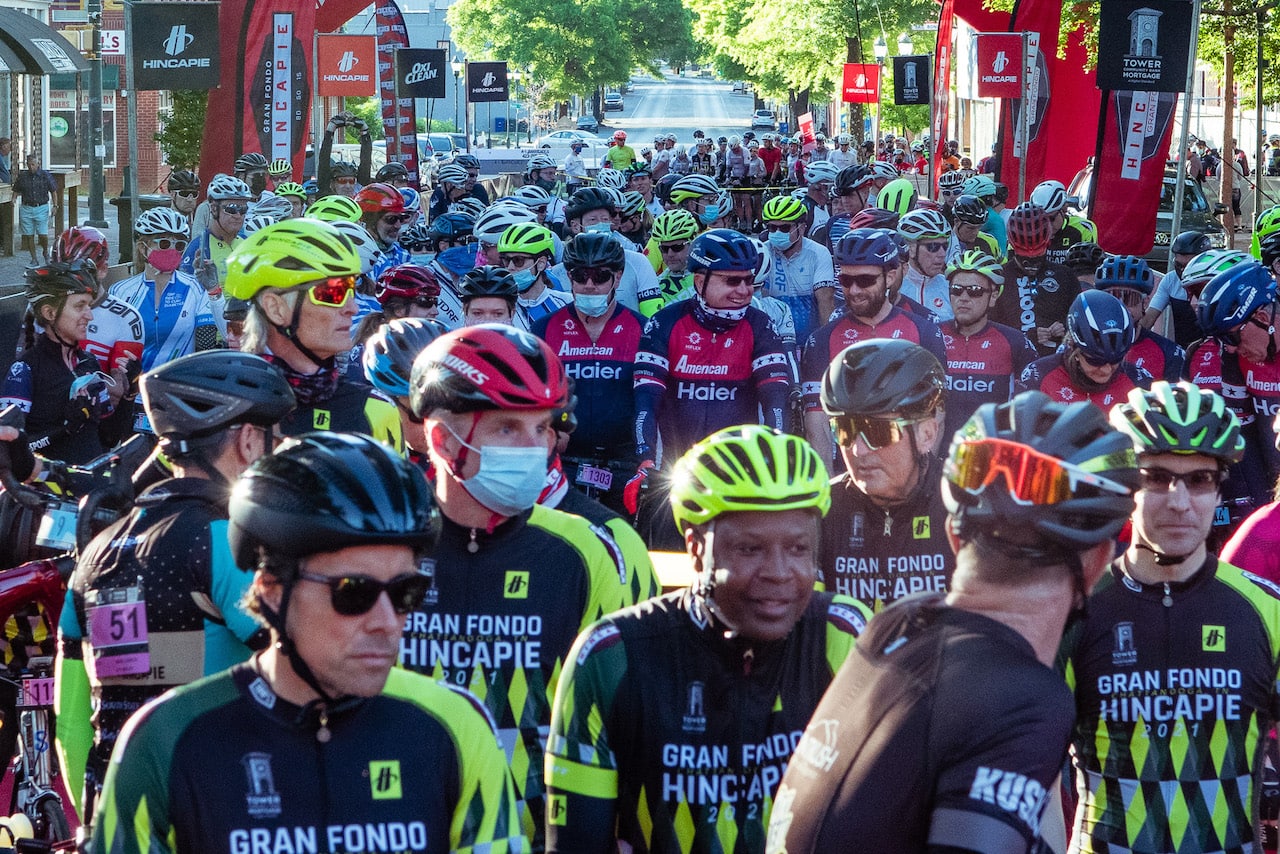 large group of cyclists wearing bike helmets