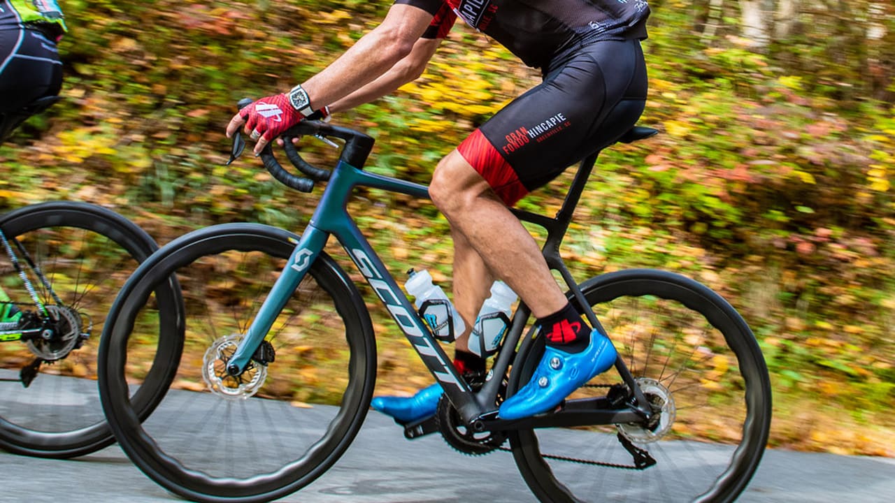 cyclist wearing blue cycling shoes