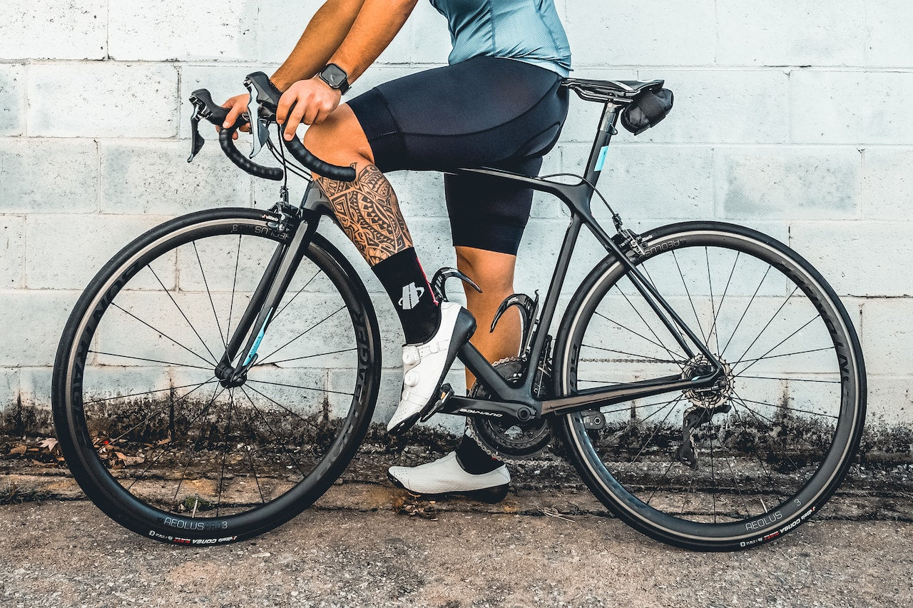 cyclist wearing black logo socks